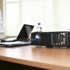 Computer projector and laptop on table in boardroom