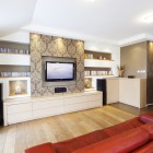 Wraparound cabinets and red sofa