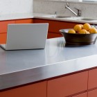 Laptop and bowl of fruit on kitchen counter